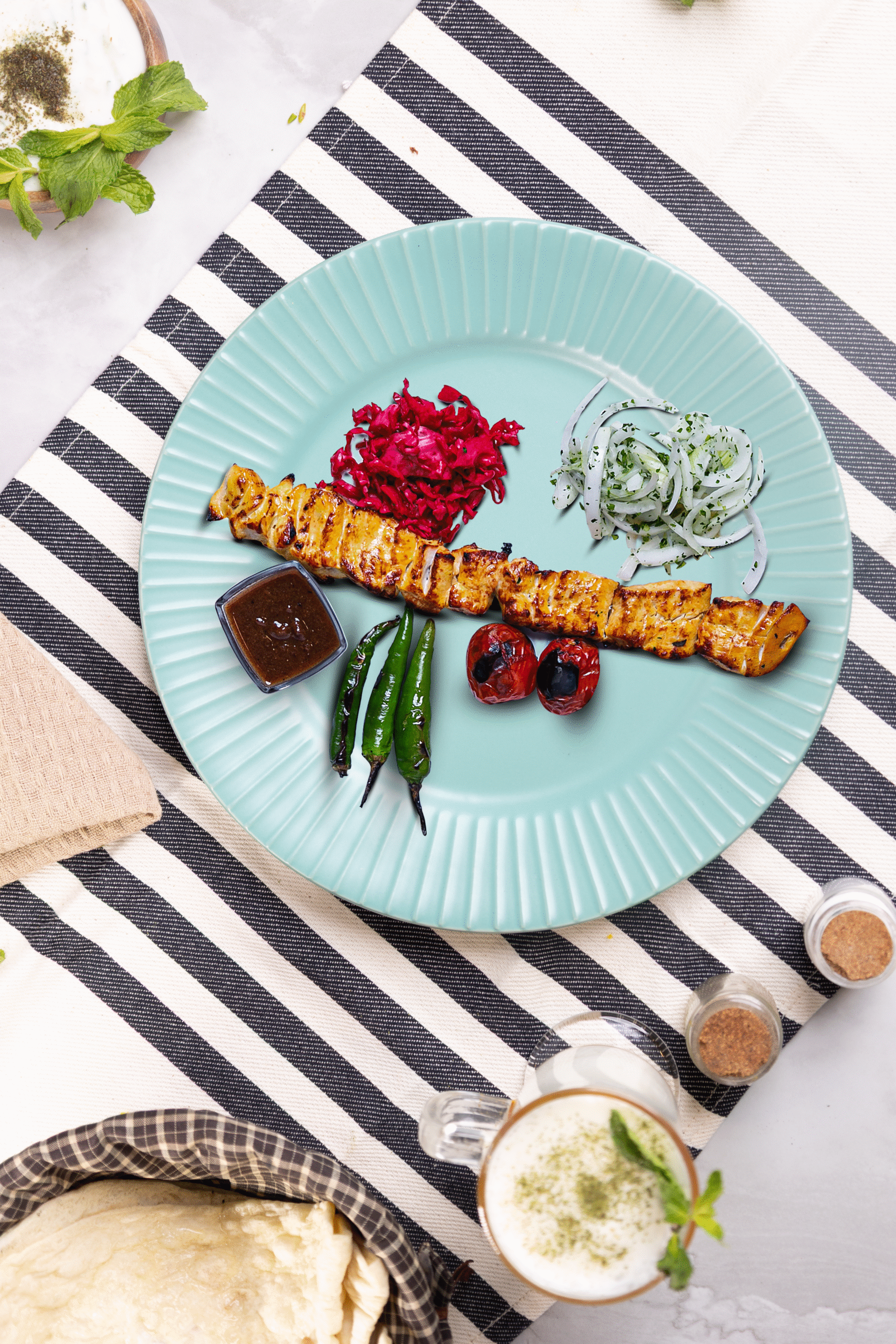 Juicy chicken kebabs served with saffron rice and grilled tomatoes at Layali Al Rabee, the Best Iranian Restaurant in Abu Dhabi.